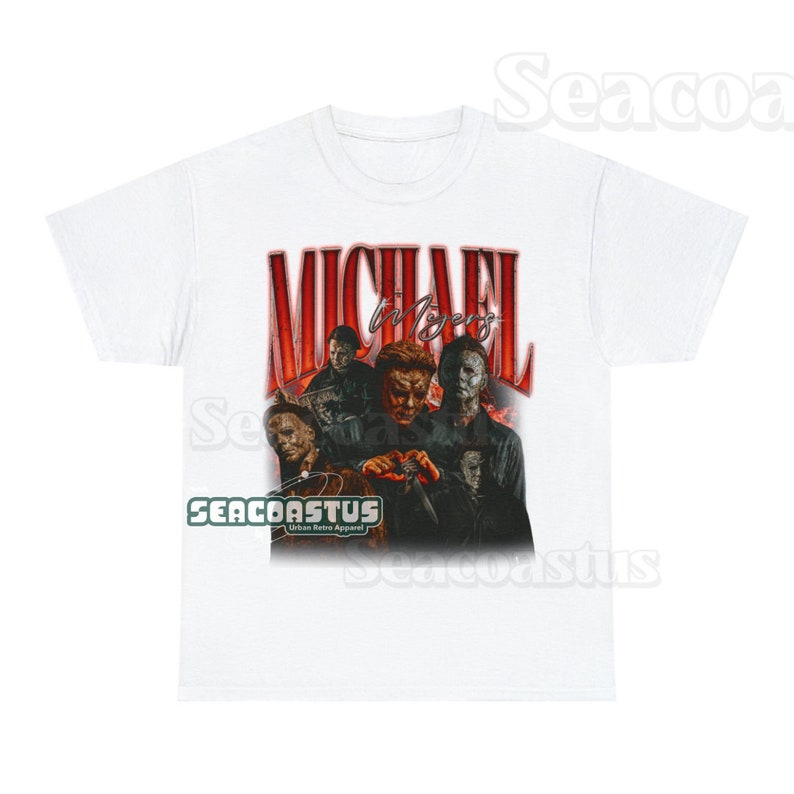 May include: White t-shirt with a vintage-style graphic of Michael Myers from the Halloween franchise. The graphic features multiple images of Michael Myers in different poses, with the text "MICHAEL MYERS" in red and black letters.