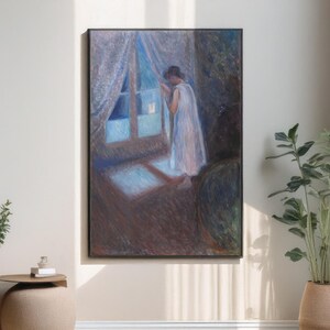 May include: A framed artwork depicts a person in a white dress looking out a window. The painting has a soft, impressionistic style with muted blues, browns, and whites. The window and curtains are visible, with light streaming in.