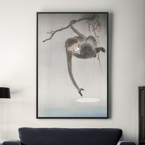 May include: A black and white painting of a monkey hanging from a tree branch. The monkey is reaching out with its hand towards a white circle in the sky.