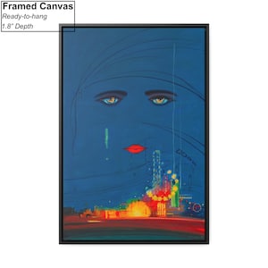 May include: Framed canvas print of a stylised woman's face with blue eyes and red lips. The background is a dark blue with a cityscape in the bottom half of the image.