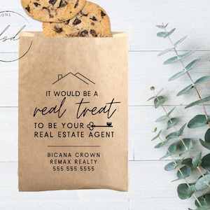 May include: A brown paper bag with a real estate agent business card. The bag has the text "It would be a real treat to be your real estate agent." The business card has the text "Bicana Crown, Remax Realty, 555.555.5555".