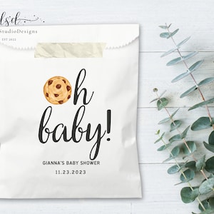May include: White paper bag with a brown chocolate chip cookie illustration and the text "Oh baby!"  Gianna's Baby Shower 11.23.2023.