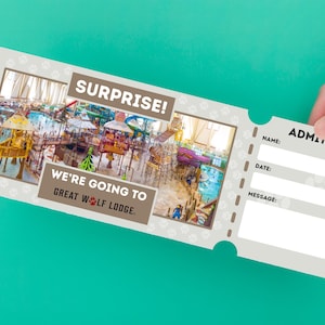 May include: A Great Wolf Lodge admission ticket with a photo of a water park. The ticket has the words "SURPRISE!" and "WE'RE GOING TO GREAT WOLF LODGE." The ticket is held by a hand against a teal background.