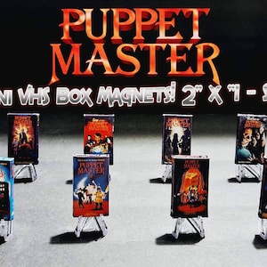May include: Set of eight 2-inch mini VHS box magnets featuring the Puppet Master horror film series. Each magnet features a different movie poster from the series.