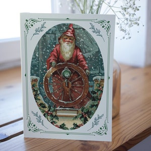 Nautische kerstkaart, vintage Kerstman aan het roer van een schip, Zeilen, Koopvaardij, Koninklijke Marine, schip, boot, groot schip, zeilboot