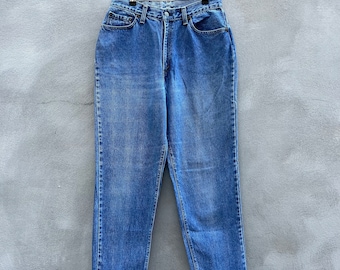 May include: A pair of blue denim jeans with a high waist and a frayed hem.