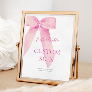 May include: A gold-framed sign with a pink watercolor bow and the text "fully editable CUSTOM SIGN design & print unlimited signs for your event".