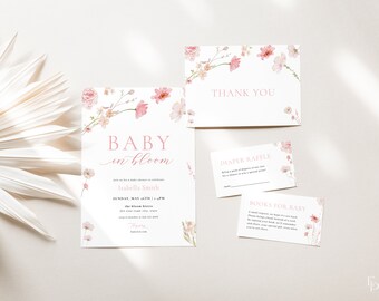 May include: Pink floral baby shower invitation with the text "Baby in Bloom" and the name "Isabella Smith". The invitation includes the date and time of the shower, the location, and the RSVP information. There are also cards for a diaper raffle and a book request for the baby.