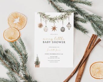 May include: A white baby shower invitation with gold lettering that reads "merry little baby shower". The invitation features a watercolor illustration of a garland of greenery with ornaments hanging from it.