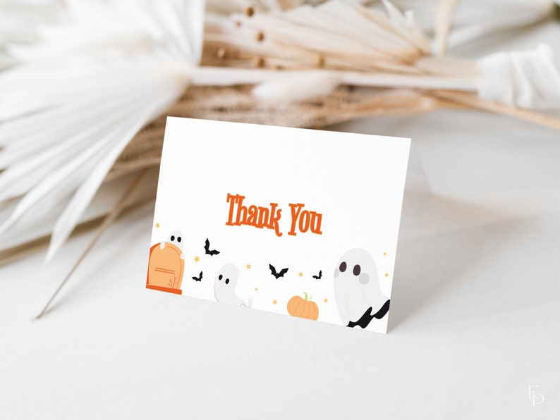 May include: A white thank you card with the text "Thank You" in orange. The card is decorated with cartoon ghosts, bats, and a pumpkin.