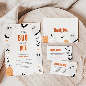 May include: A set of three white cards with orange and black accents. The main card features a ghost and bat illustration with the text "a little BOO is almost DUE" and "Join us for a baby shower honouring Amelia Harvey". The second card says "Thank You" and the third card says "Diaper Raffle".