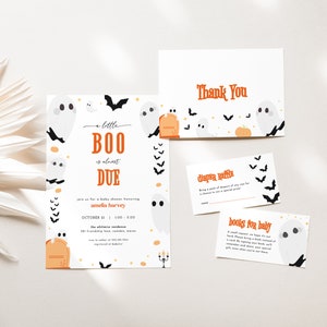 May include: A Halloween-themed baby shower invitation featuring a ghost and bat design. The invitation reads "A Little Boo is Almost Due" and includes the name Amelia Harvey, the date 31st October, and the time 1:00-3:00. There are also thank you cards, a diaper raffle card, and a books for baby card.