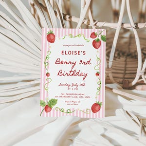 May include: A pink and white striped invitation card with the text "ELOISE'S Berry 3rd Birthday". The card features watercolor strawberries and green vines. The invitation includes the date, time, and location.