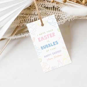 May include: A white Easter gift tag with pastel bubble and bunny illustrations. The tag reads "I hope your Easter is bubbles of fun! Happy Easter!" and includes a brown string for hanging.