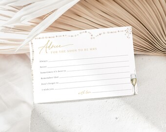 May include: White card with gold glitter border and gold lettering. The card says "Advice for the soon to be Mrs." and has lines for writing advice. There is a small illustration of a champagne flute on the right side of the card.