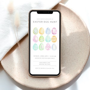 May include: A digital invitation for an Easter egg hunt. The invitation features a watercolor illustration of colorful Easter eggs and the text "Easter Egg Hunt". The invitation also includes the date, time, and location of the event.