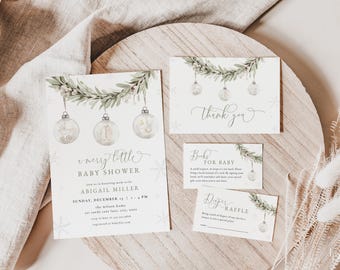 May include: A set of four cards for a baby shower with a winter theme. The main card is a white invitation with a green garland of leaves and ornaments. The text reads "A merry little baby shower" and includes the name "Abigail Miller". The other cards are a thank you card, a "Books for Baby" card, and a "Diaper Raffle" card.