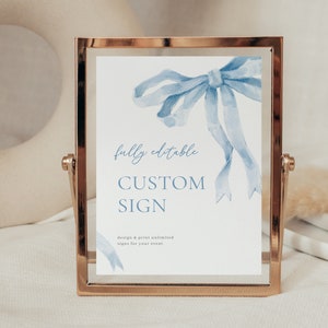 May include: A gold-framed sign with a blue watercolour bow and the text "fully editable CUSTOM SIGN design & print unlimited signs for your event".