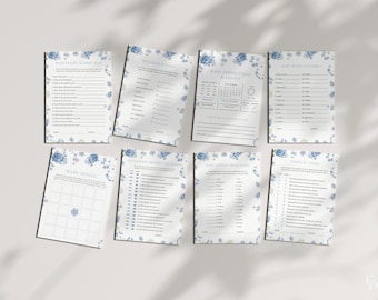 May include: A collection of baby shower game cards with a floral design. The cards feature various games like "Baby Bingo" and "Guess Who Mommy or Daddy". Each card has a white background with blue floral borders and text.