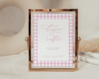 May include: A pink and white gingham patterned sign in a gold frame with the text "diaper raffle" and "please place your diapers and raffle cards here" and "thank you for your gift".