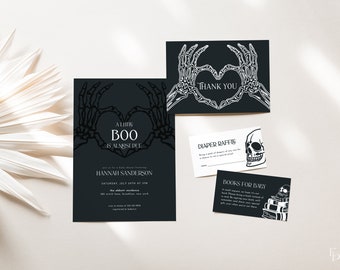 May include: A black and white invitation for a baby shower with a skeleton hand heart design. The invitation reads "A Little Boo is Almost Due" and includes the name "Hannah Sanderson".