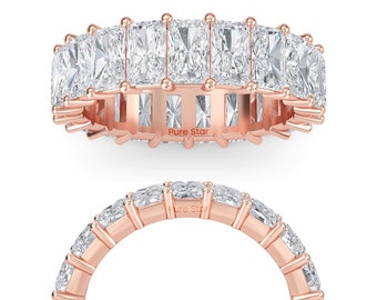 May include: Rose gold eternity ring featuring rectangular-cut, clear gemstones. The ring has a band with the text "Pure Star" engraved on it. The gemstones are set closely together, creating a continuous sparkle.
