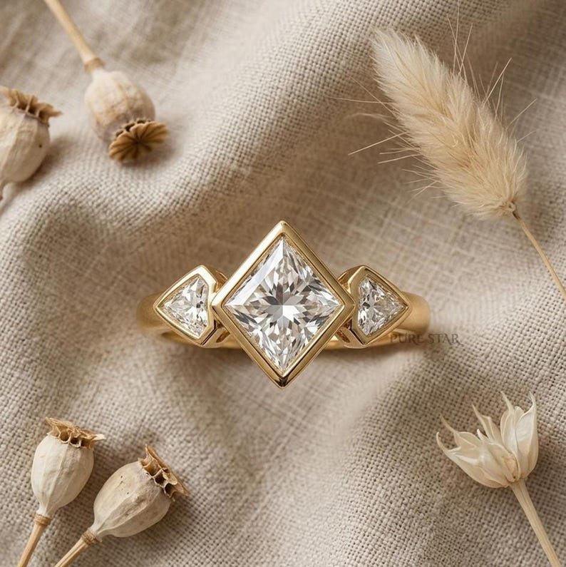 2 carat princess cut lab grown diamond three stone engagement ring with bezel setting and shield side diamonds.