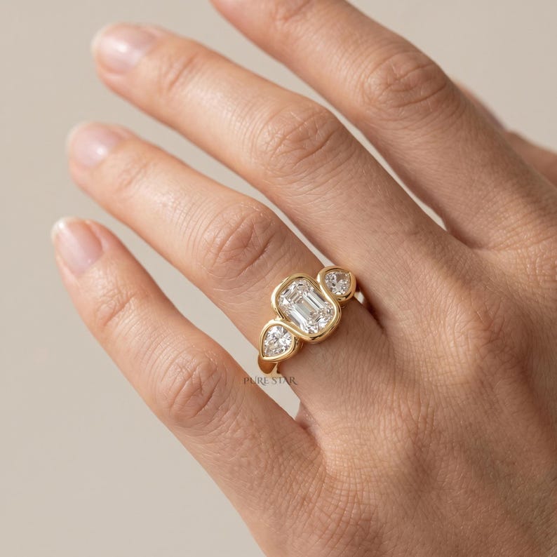 Modern bezel set engagement ring with lab grown diamond and yellow gold band.