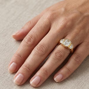 Luxury yellow gold bridal ring featuring cushion cut center diamond and half moon diamond accents.