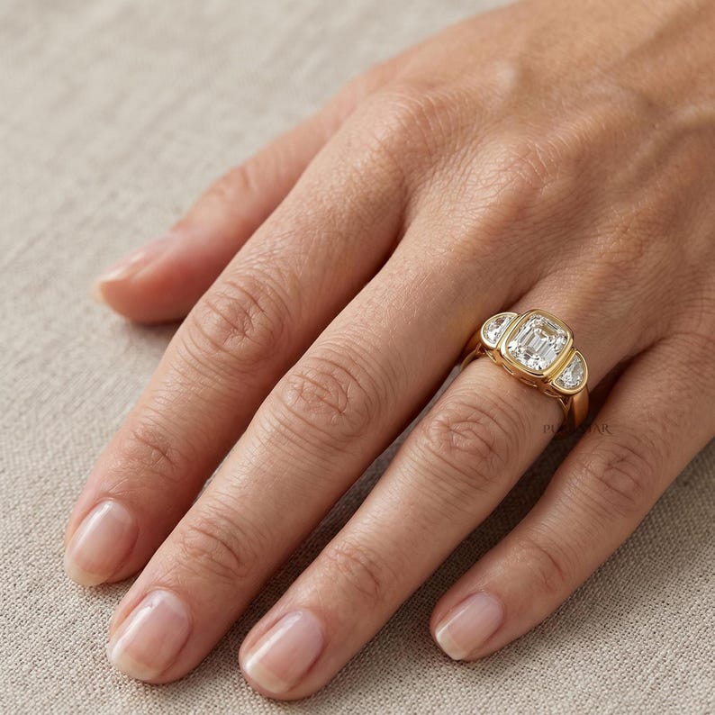 Luxury yellow gold bridal ring featuring cushion cut center diamond and half moon diamond accents.