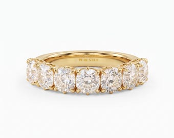 May include: A yellow gold band ring featuring seven round, brilliant-cut clear stones set in individual prongs. The interior of the band is engraved with the text PURE STAR in a clean, sans-serif font, centered along the inner surface.