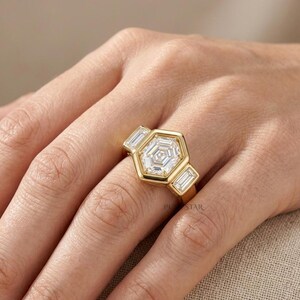 Modern hexagon diamond ring featuring bezel set center stone and geometric bridal design.