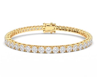 May include: A gold tennis bracelet featuring a continuous row of round, clear, faceted stones set in a polished gold metal frame. The clasp mechanism is engraved with the text PURE STAR and includes a secure locking hinge.