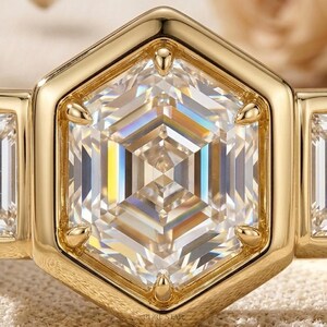 Luxury bezel engagement ring showcasing hexagon center diamond and side baguette stones.