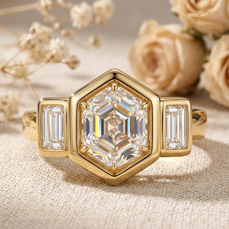 Hexagon lab grown diamond three stone engagement ring with full bezel setting and baguette side diamonds.