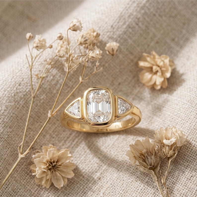 modern bezel set engagement ring with 2 carat cushion cut diamond and trillion accent stones