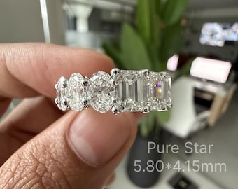 May include: A silver-toned ring featuring a row of alternating oval and emerald-cut clear stones set in a metal band. The text Pure Star 5.80*4.15mm is visible on the lower right side of the image, indicating specific stone dimensions.