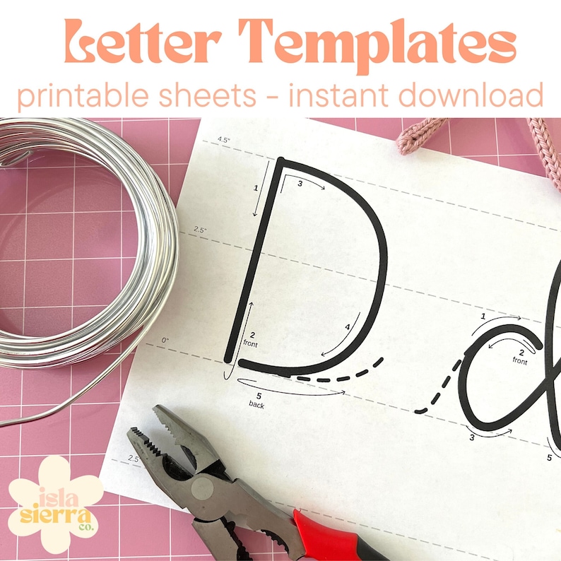 May include: Printable letter templates for crafting. The image shows a close-up of a template for the letter "D" with numbered steps and arrows showing the order of wire wrapping. The template is printed on white paper and there is a roll of silver wire, pliers, and a pink surface in the background.