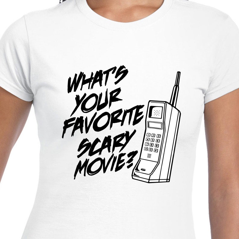 May include: White t-shirt with black text that reads "What's your favorite scary movie?" and a black and white illustration of a vintage rotary phone.