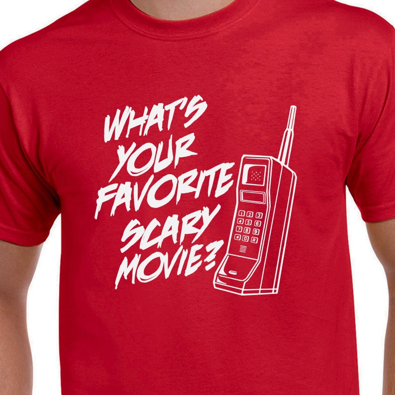 May include: Red t-shirt with a white graphic of a vintage cell phone and the text "What's your favorite scary movie?"