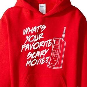 May include: Red hooded sweatshirt with white text that reads "What's your favorite scary movie?" and a white outline of a vintage rotary phone.