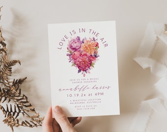 May include: A bridal shower invitation with the text "Love is in the Air" and floral heart design in pink, purple, and orange. The invitation includes details for Annabelle Harris's shower in Melbourne, Australia.