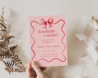 May include: Pink save the date card with a red border and a pink bow. The text reads "Annabelle & Robert are getting married!! Save the Date 11.19.2X Melbourne, Australia Invitation to Follow."