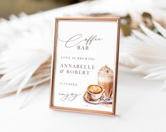 Könnte beinhalten: Ein gerahmtes Schild mit roségoldfarbenem Rand, das "Coffee Bar" in eleganter Schrift zeigt. Das Schild enthält den Text "Love is Brewing", Namen und ein Datum sowie Aquarellillustrationen von Kaffeegetränken.