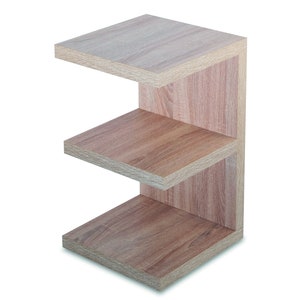 Puede incluir: Una estanter&iacute;a de madera con tres estantes. Los estantes son de madera marr&oacute;n claro y tienen un acabado natural. La unidad est&aacute; dise&ntilde;ada en forma de L, con los estantes que se extienden hacia afuera desde la parte posterior.