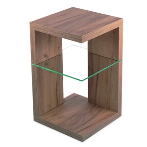 May include: A wooden end table with a glass shelf. The table has a brown wood finish and a square shape.
