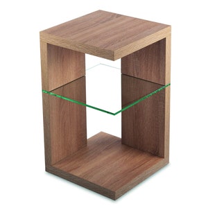 May include: A wooden end table with a glass shelf. The table has a light brown finish and a square shape.