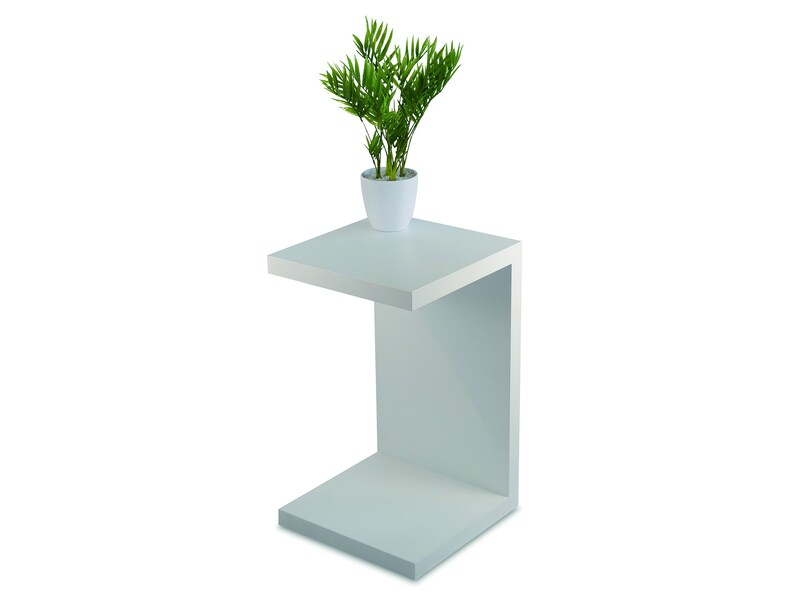 May include: White side table with a single shelf. The table has a modern design and is made of wood. A small potted plant sits on the top shelf.