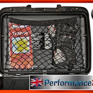 May include: Black motorcycle top case with a black mesh cargo net. The net is holding a map of France and a pair of black motorcycle gloves.