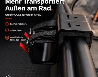 Puede incluir: Un portaequipajes negro UrbanHOOKS para bicicleta, diseñado para el modelo Urban Arrow. El soporte está montado en una barra negra y asegurado con correas negras y detalles rojos. El texto de la imagen dice "Mehr Transportiert Außen am Rad."
